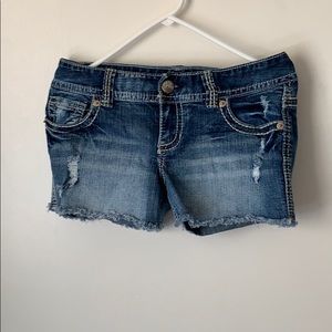 Dark blue distressed denim shorts with fraying